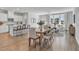 Open concept kitchen with island, white cabinets, and hardwood floors at 8947 Kennebec Crossing Dr # 53, Angier, NC 27501