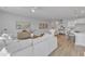 Open concept living room with white sectional sofa and hardwood floors at 8947 Kennebec Crossing Dr # 53, Angier, NC 27501