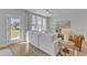 Living room with white sectional sofa and access to patio at 8947 Kennebec Crossing Dr # 53, Angier, NC 27501