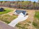 An aerial view showcases a new construction home, long driveway, and surrounding landscape at 9342 Turkey Way, Middlesex, NC 27557