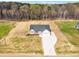 An aerial shot of a new construction home and long driveway surrounded by newly installed sod at 9342 Turkey Way, Middlesex, NC 27557