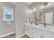 Modern bathroom featuring double sinks, white cabinets, and sleek black fixtures at 9342 Turkey Way, Middlesex, NC 27557