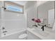 Clean bathroom featuring white fixtures, a window, and an elegant countertop at 9342 Turkey Way, Middlesex, NC 27557