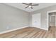 Spacious bedroom featuring a modern ceiling fan, wood-look floors, and a double closet at 9342 Turkey Way, Middlesex, NC 27557