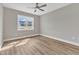 Well-lit bedroom with neutral walls, a ceiling fan, and a view to the community outside at 9342 Turkey Way, Middlesex, NC 27557