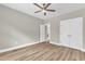 Bedroom with modern ceiling fan, wood-look floors, and access to other rooms at 9342 Turkey Way, Middlesex, NC 27557