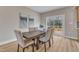 Elegant dining area with a large table, slider to the deck, and stylish decor at 9342 Turkey Way, Middlesex, NC 27557