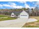 Charming new construction features a welcoming porch, attached two-car garage, and long concrete driveway at 9342 Turkey Way, Middlesex, NC 27557
