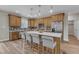 Stylish kitchen with bar stool seating, gray backsplash, stainless steel appliances and modern lighting at 9342 Turkey Way, Middlesex, NC 27557