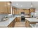 Well-lit kitchen featuring wood cabinets, stainless steel appliances, and a stylish backsplash at 9342 Turkey Way, Middlesex, NC 27557
