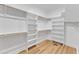 Spacious walk-in closet with custom shelving and wooden rods for ample storage at 9342 Turkey Way, Middlesex, NC 27557
