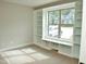 Bedroom featuring custom built-in shelves and a window overlooking a home across the street at 100 Churchill Rd, Louisburg, NC 27549
