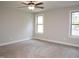 Neutral bedroom with large windows and carpet flooring at 100 Churchill Rd, Louisburg, NC 27549
