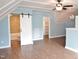 Bonus room featuring tile floors and a barn door to the bathroom at 100 Churchill Rd, Louisburg, NC 27549