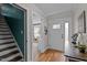 Inviting foyer with hardwood floors, front door with sidelight, and stairs to the second floor at 100 Churchill Rd, Louisburg, NC 27549
