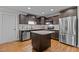 Kitchen with dark cabinets, granite island, and stainless steel appliances at 100 Churchill Rd, Louisburg, NC 27549