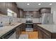 Modern kitchen with stainless steel appliances, granite countertops, and ample cabinet space at 100 Churchill Rd, Louisburg, NC 27549