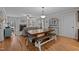 Open-concept living room featuring hardwood floors, a cozy fireplace, and dining area at 100 Churchill Rd, Louisburg, NC 27549