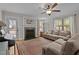 Cozy living room featuring a fireplace, large windows, and comfortable seating at 100 Churchill Rd, Louisburg, NC 27549