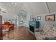Living room featuring an electric fireplace, chandelier, and hardwood floors at 100 Churchill Rd, Louisburg, NC 27549