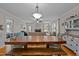 Bright, open-concept living room with a dining area and a view of the kitchen at 100 Churchill Rd, Louisburg, NC 27549