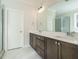 Elegant bathroom featuring double sink vanity with granite countertops and tiled floors at 116 Bearwallow Forest Way, Wendell, NC 27591