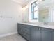 Double vanity bathroom with gray cabinets and quartz countertops at 116 Bearwallow Forest Way, Wendell, NC 27591