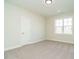 A bright room with carpet and a window and white door at 116 Bearwallow Forest Way, Wendell, NC 27591