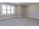 Spacious bedroom with neutral walls, plush carpeting, and a large window for ample natural light at 116 Bearwallow Forest Way, Wendell, NC 27591