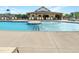 Community pool with ample seating and a covered area for relaxation on a sunny day at 116 Bearwallow Forest Way, Wendell, NC 27591