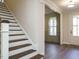 Welcoming entryway with hardwood staircase and a view into the dining room at 116 Bearwallow Forest Way, Wendell, NC 27591