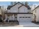 Charming two-story home with a covered porch, neutral siding, and an attached two-car garage at 116 Bearwallow Forest Way, Wendell, NC 27591