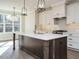 Bright eat-in kitchen with white countertops and cabinets, complemented by wooden floors and stainless steel fixtures at 116 Bearwallow Forest Way, Wendell, NC 27591