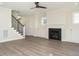 Open-concept living space with a staircase, fireplace, and built-in cabinets at 116 Bearwallow Forest Way, Wendell, NC 27591