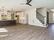 Spacious living room flows into modern kitchen with an island and staircase to upper level at 116 Bearwallow Forest Way, Wendell, NC 27591