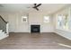 Cozy living room featuring a fireplace, built-in shelving, and large windows at 116 Bearwallow Forest Way, Wendell, NC 27591
