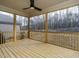 Inviting screened porch with wood flooring and ceiling fan, perfect for relaxing and enjoying the outdoors at 116 Bearwallow Forest Way, Wendell, NC 27591