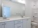 Bathroom boasts double vanity with white cabinets and drawers, next to a shower and toilet at 121 Big Bradley Way, Wendell, NC 27591