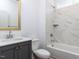 A bathroom with a vanity, toilet, and tiled shower-bath combo with a built-in shelf at 121 Big Bradley Way, Wendell, NC 27591