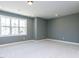 Stylish bedroom with plush carpet, large window offering ample natural light, and neutral color scheme at 121 Big Bradley Way, Wendell, NC 27591