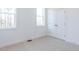 A bedroom with neutral carpet, trim, and white walls features a large double door closet at 121 Big Bradley Way, Wendell, NC 27591