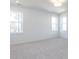 Bright bedroom with plush carpeting, large windows offering ample natural light, and neutral color scheme at 121 Big Bradley Way, Wendell, NC 27591