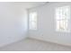 Bedroom featuring neutral carpet, white trim and walls and two windows at 121 Big Bradley Way, Wendell, NC 27591