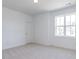 Bright bedroom featuring plush carpet, large window for natural light, neutral wall color, and recessed lighting at 121 Big Bradley Way, Wendell, NC 27591