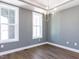 Dining room featuring wood floors, neutral walls, and modern chandelier at 121 Big Bradley Way, Wendell, NC 27591