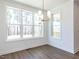A bright dining area boasts natural light, contemporary chandelier, and views of the serene outdoors at 121 Big Bradley Way, Wendell, NC 27591