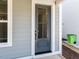 Close up of an gray entry door with a sidelight window at 121 Big Bradley Way, Wendell, NC 27591