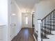 Bright entryway with wood floors, staircase, and elegant lighting at 121 Big Bradley Way, Wendell, NC 27591