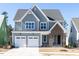 Charming two-story home with a two-car garage, brick accent, and manicured lawn at 121 Big Bradley Way, Wendell, NC 27591