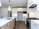 Bright kitchen features white cabinets, stainless appliances, and a large island with sink at 121 Big Bradley Way, Wendell, NC 27591